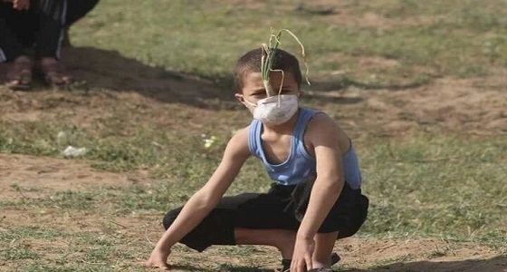 طفل فلسطيني يستخدم " بصلة " ليحمي نفسه من قنابل الغاز
