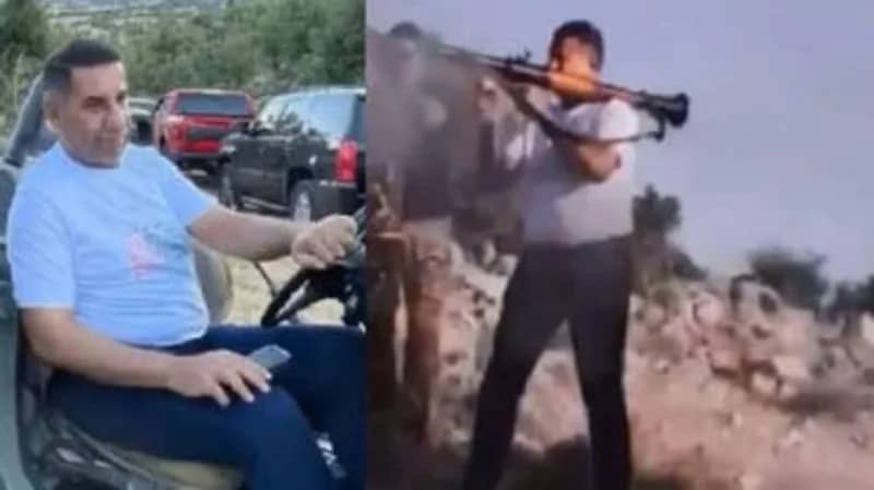 سفير العراق في لبنان يحمل قذيفة "آر بي جي" حربية