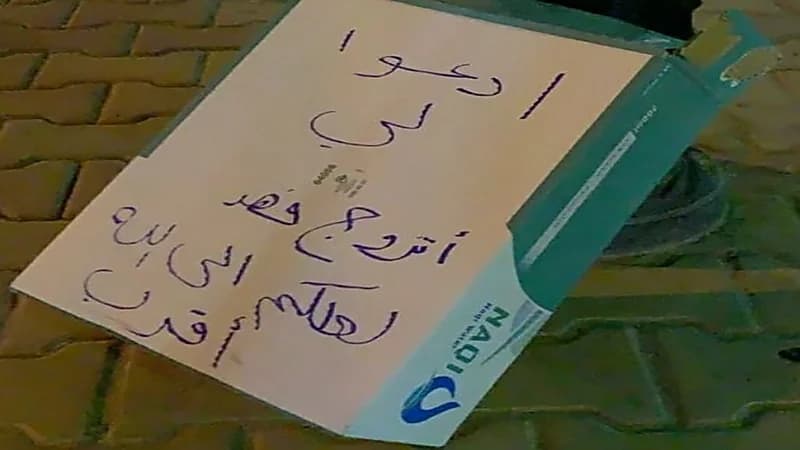 فتاة تكتب على كرتونة مياه وضعتها في ممشى كصدقة جارية: " أدعو لي أتزوج فهد "